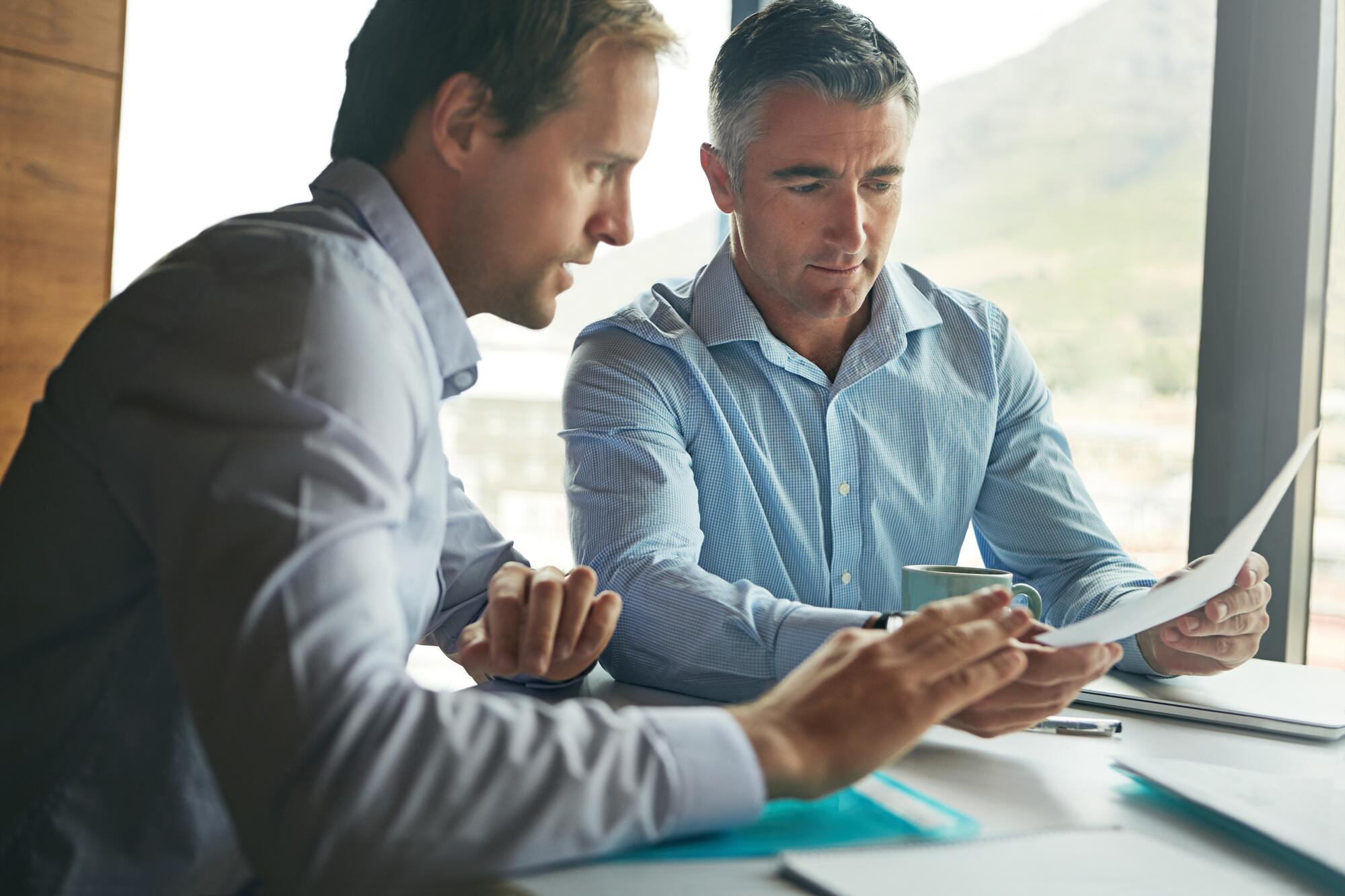 Financial professionals looking at computer